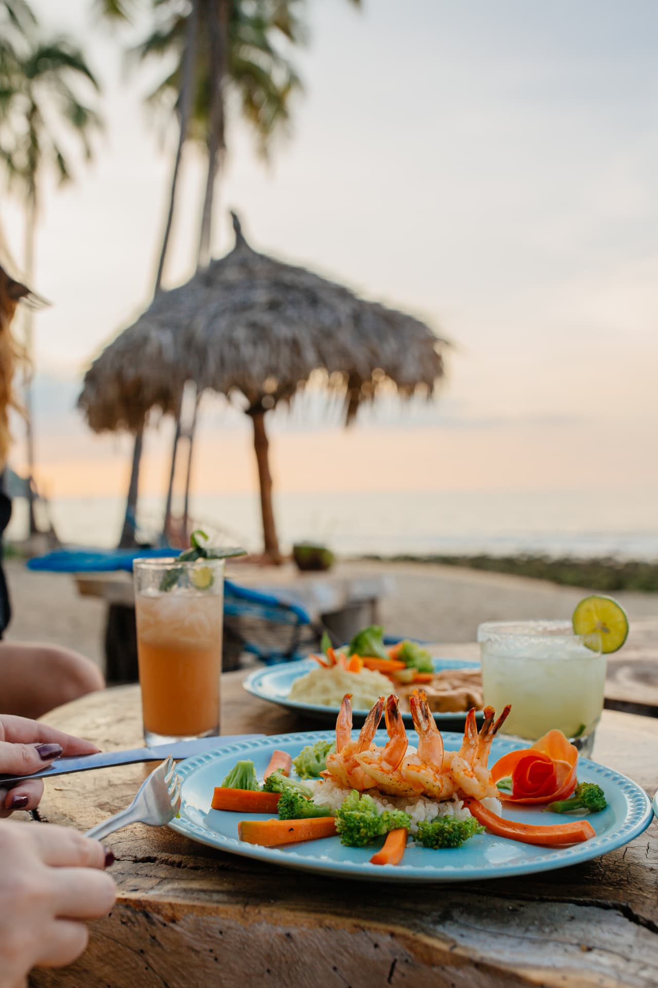 Shrimp and cocktails on the table with the beach in the background
