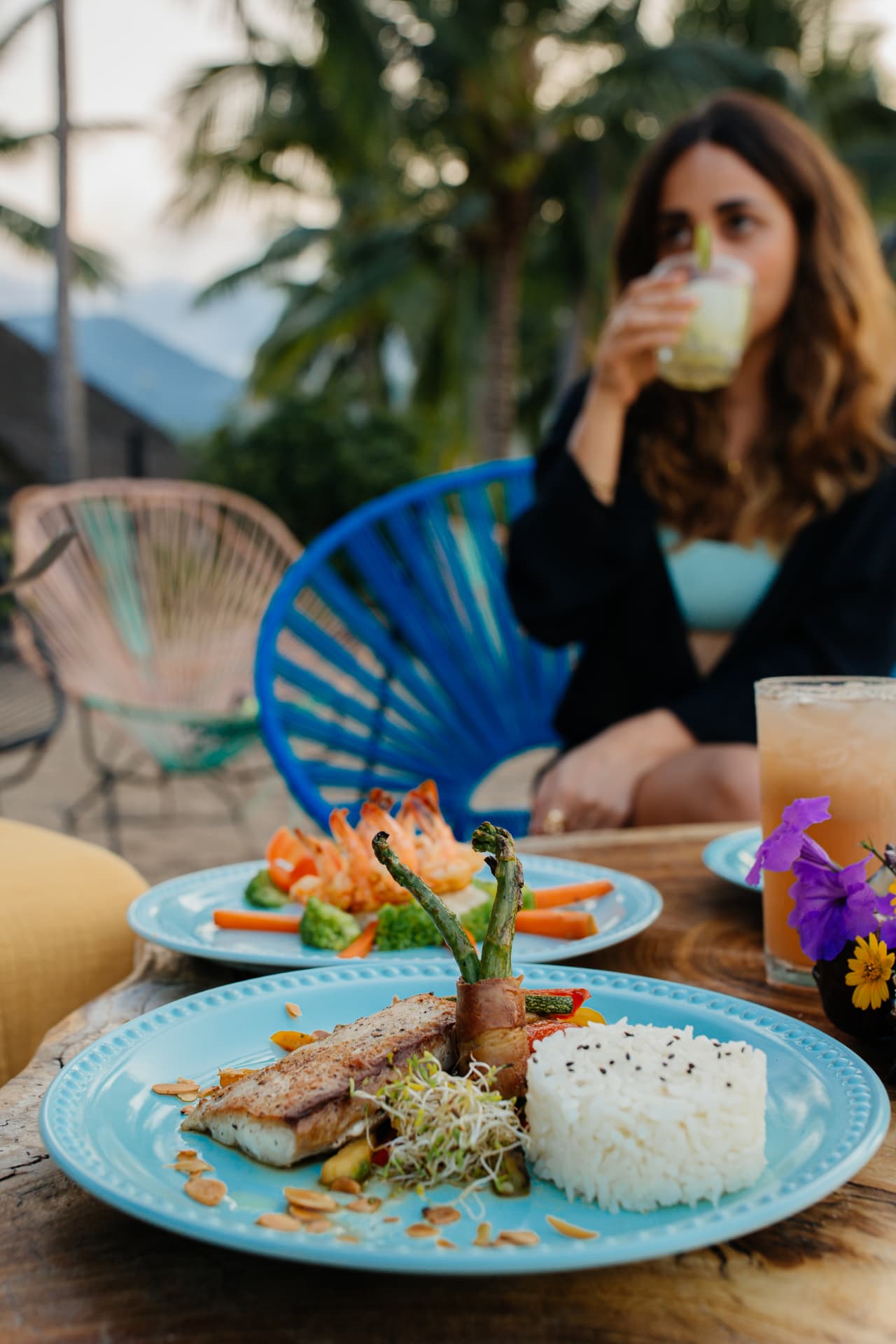 Fish fillet with rice and vegetables served at sunset