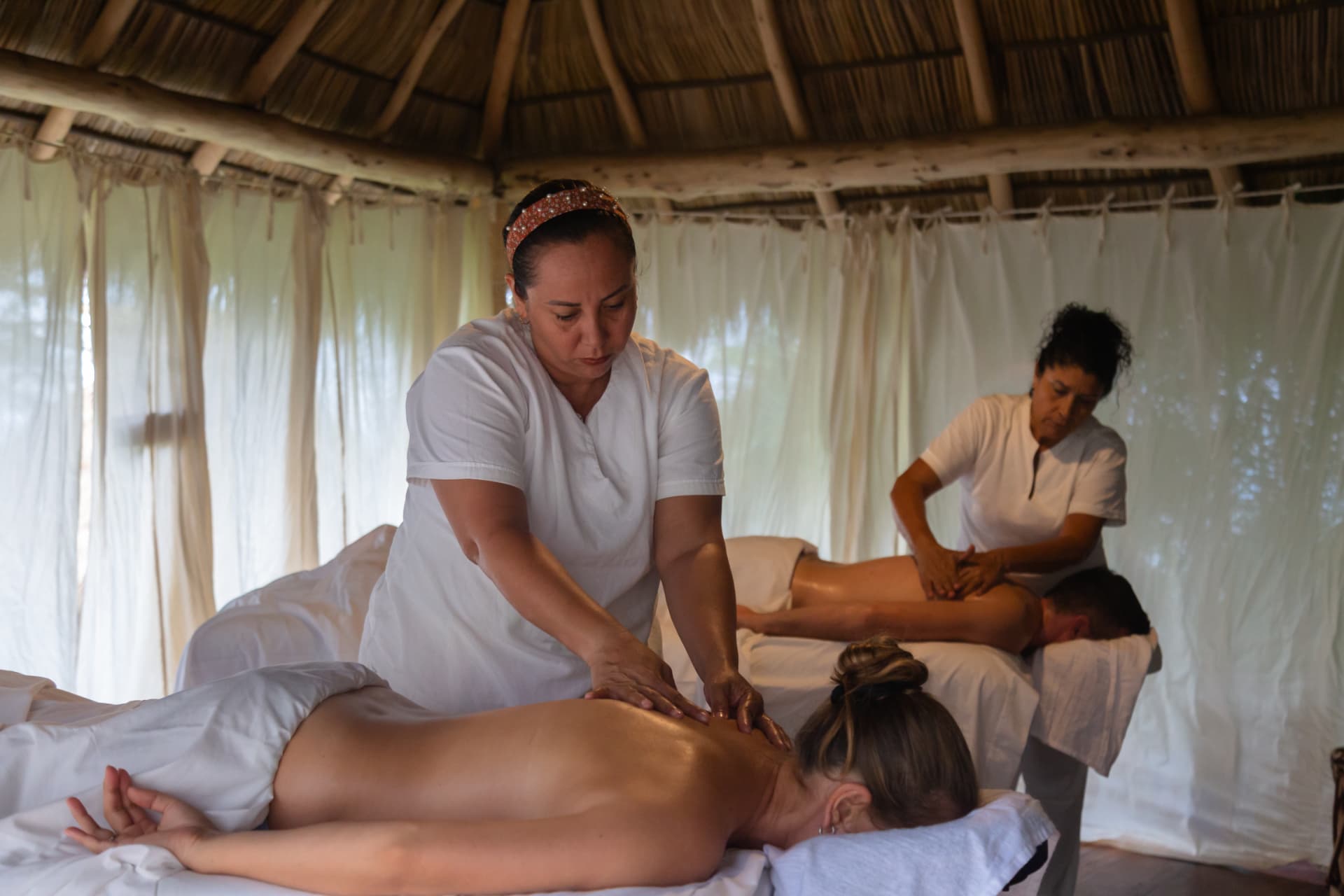 Couples massage in the spa palapa at Amaca Beach
