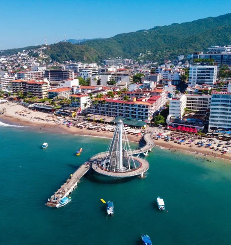 Vista aérea panorámica del malecón de Puerto Vallarta con el mar y la costa de fondo.